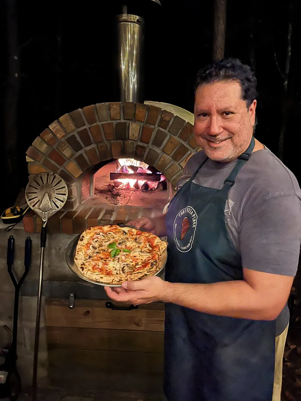 Dave cooking pizza at the wood-fired oven